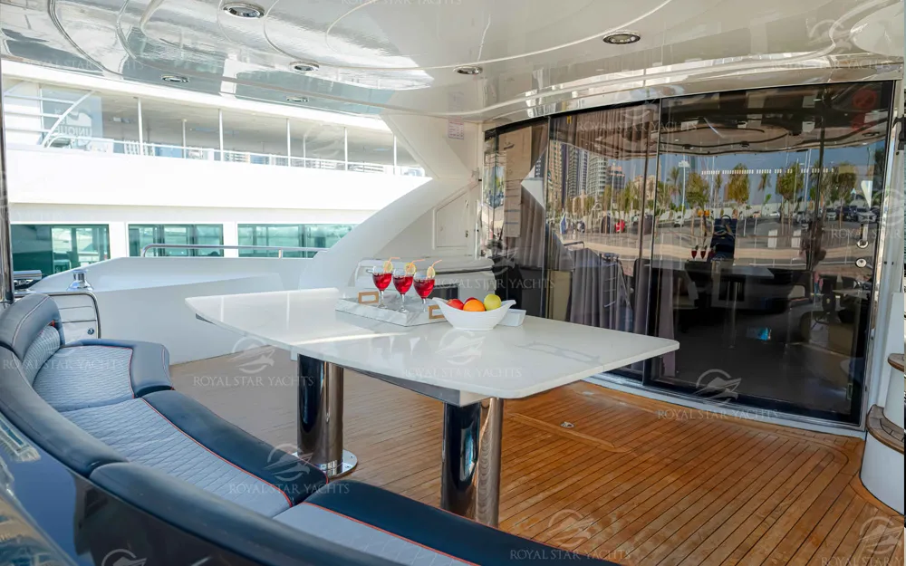Outdoor dining area with drinks setup on 90 FT Sunseeker yacht deck