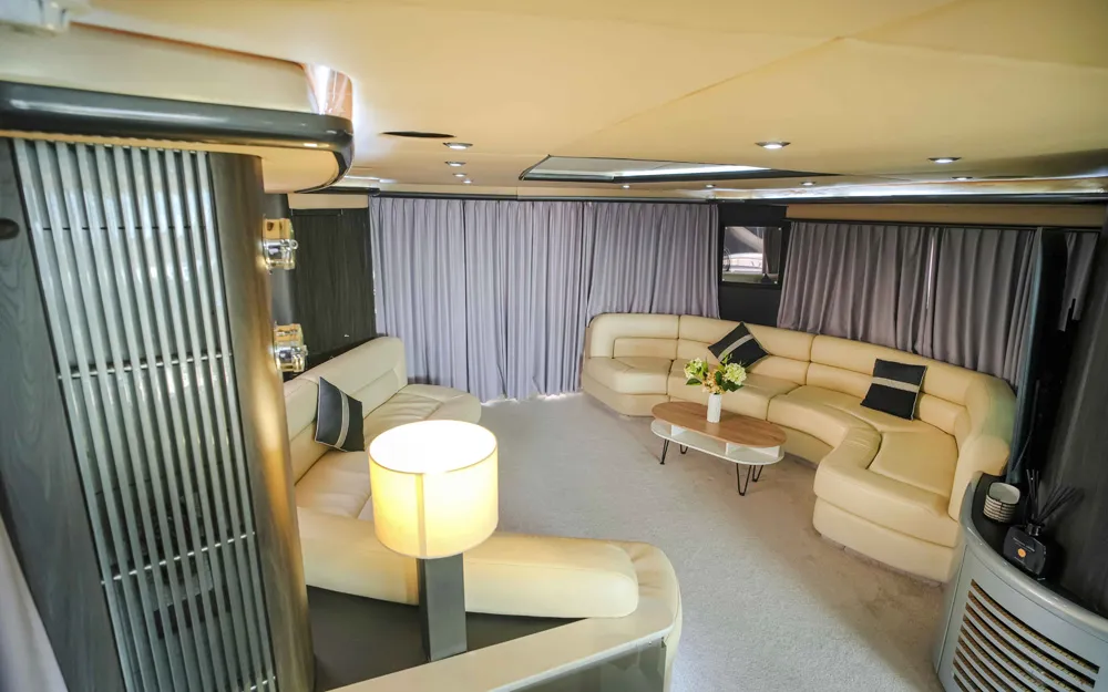 Stylish living area with curved sofas on 90 FT Sunseeker