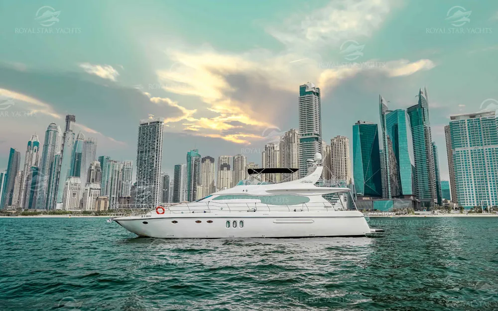 Luxury yacht Mayyas sailing at sunset with Dubai skyscrapers
