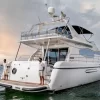Rear view of 75 FT Mayyas yacht with crew onboard in Dubai waters
