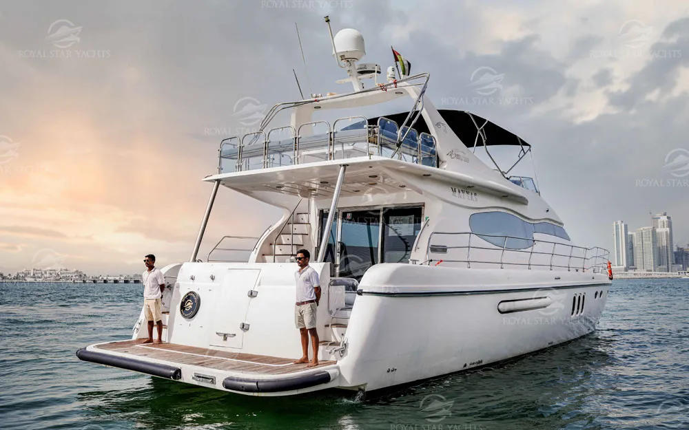 Rear view of 75 FT Mayyas yacht with crew onboard in Dubai waters