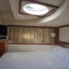 Master bedroom with TV and wide bed inside 75 FT Mayyas yacht