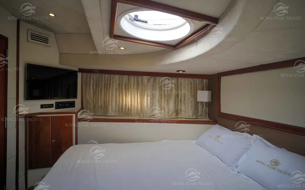 Master bedroom with TV and wide bed inside 75 FT Mayyas yacht