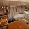 Wood finish cabin area with dining space inside Enterprise yacht Dubai