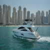Rear side view of 55 FT Integrity yacht in front of Dubai high-rises